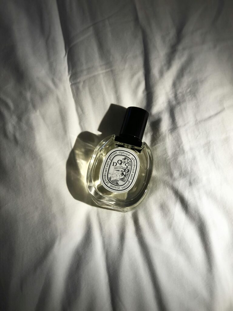 A shopper testing perfumes at a fragrance counter.